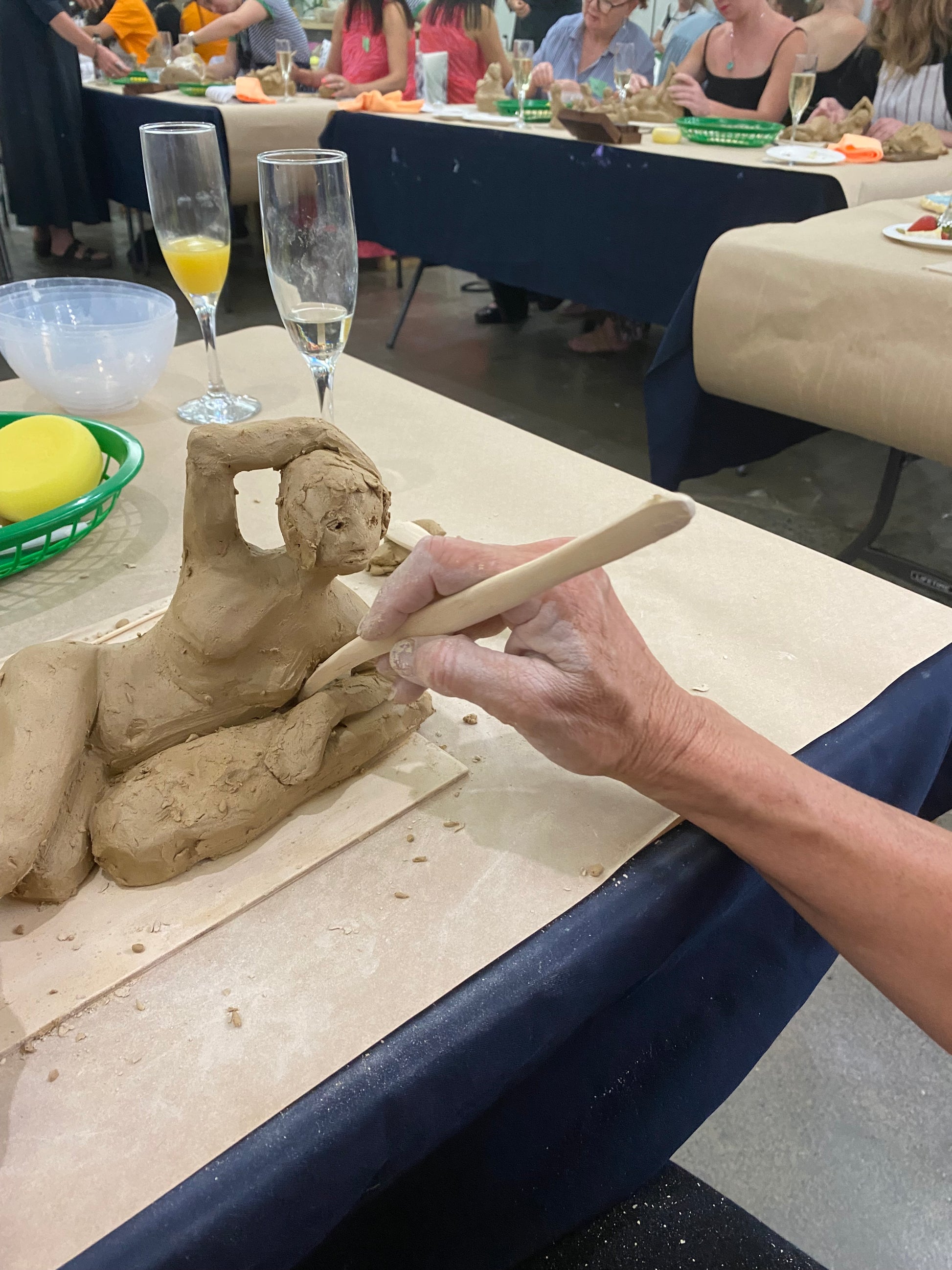 Hand modelling the figure in clay