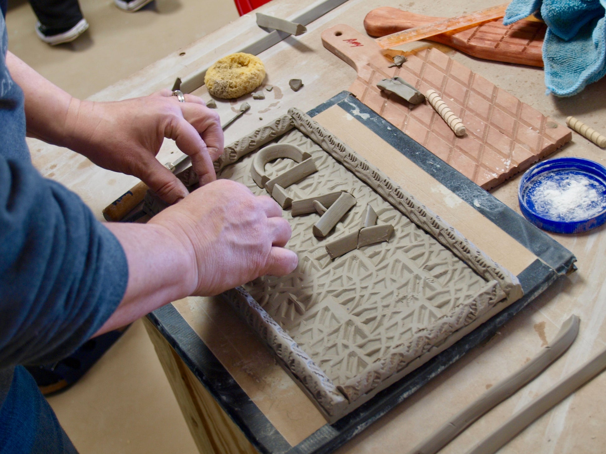 Person hand building clay object