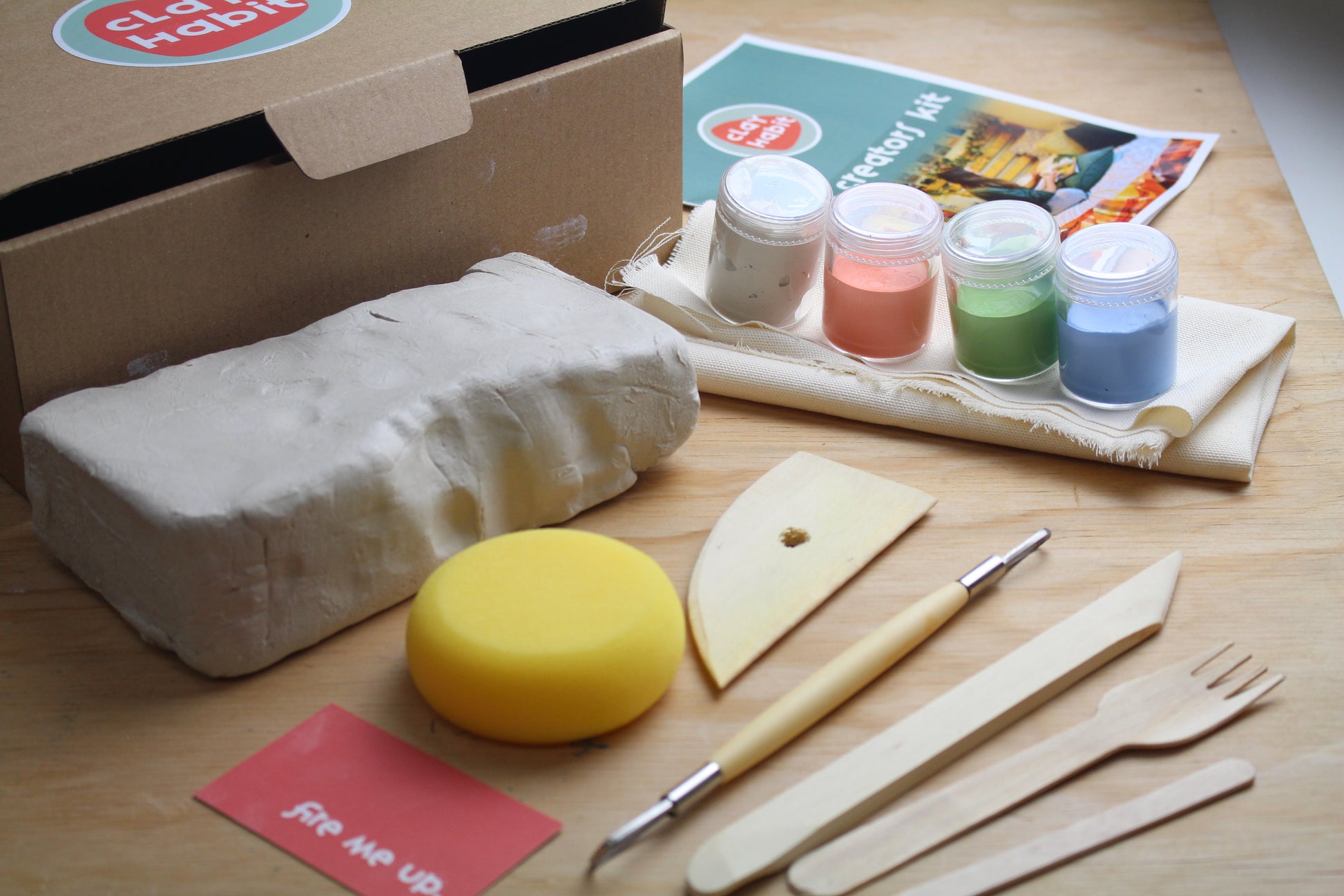 Clay slab, sponge, wooden tools, slip, glazes, cloth table mat, instruction booklet, li'l creators kit.